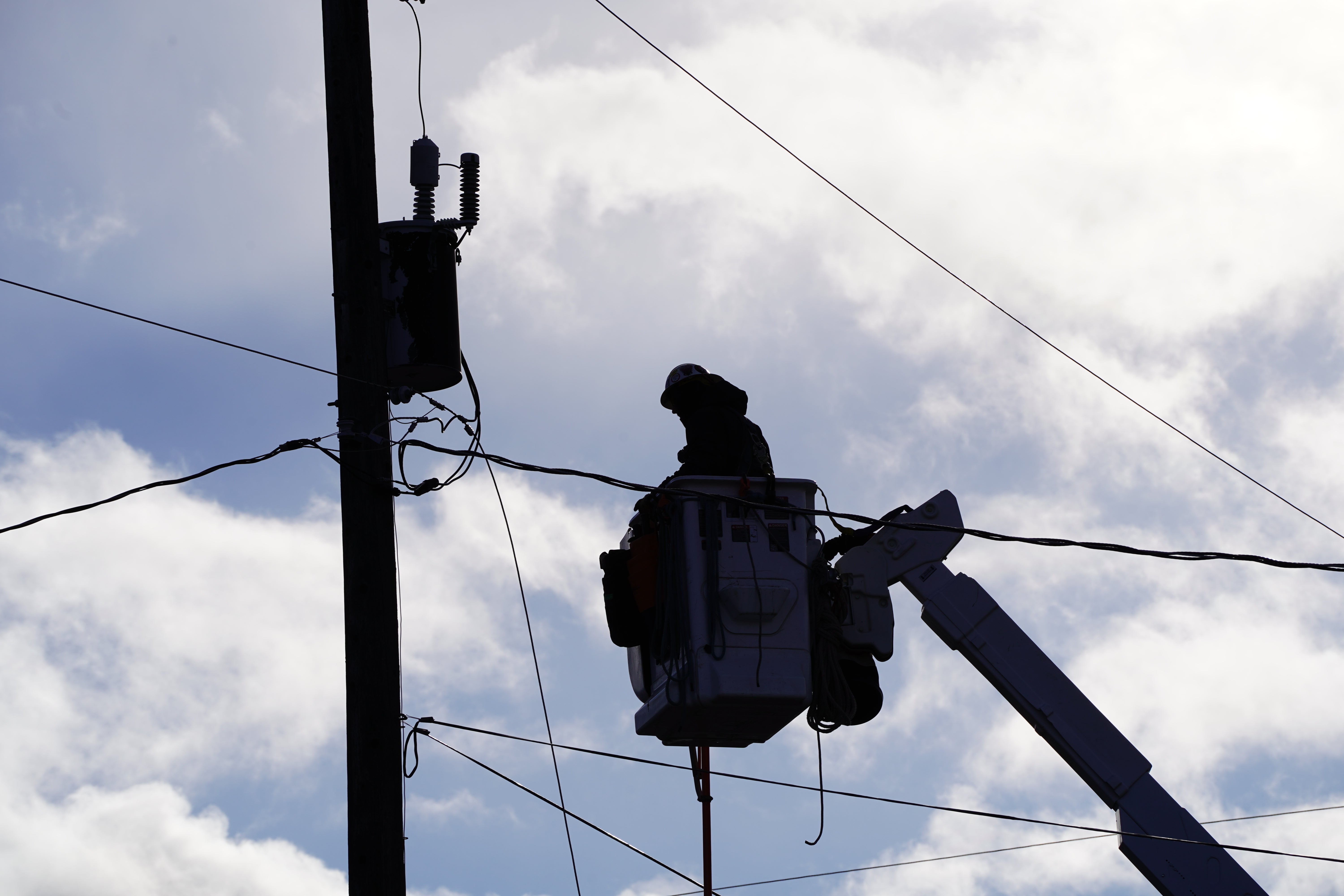 Lineman sihlouette in clouds